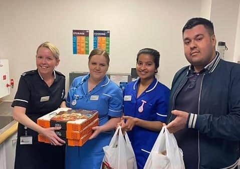 Asad Ali delivering the curries to staff at Peterborough City Hospital