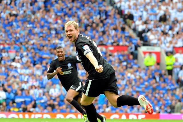 Grant McCann celebrates his goal for Posh against Huddersfield.