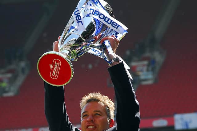 Posh boss Darren Ferguson lifts the League One play-off final winners trophy.
