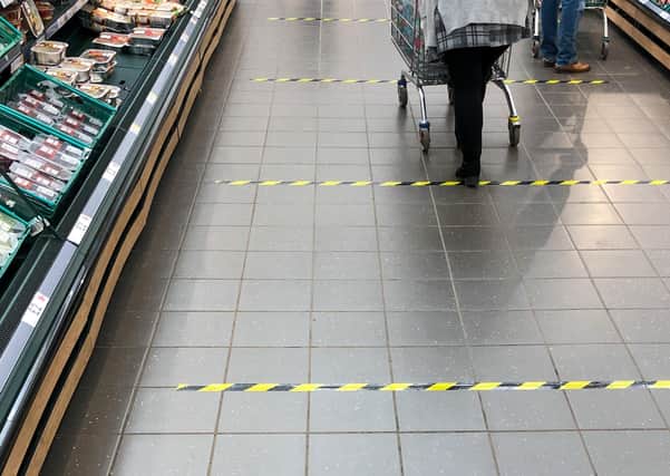 Tape marks out 2 metre sections on the floor to implement social distancing measures at a Tesco store in Peterborough, after Prime Minister Boris Johnson has put the UK in lockdown to help curb the spread of the coronavirus. Picture: Joe Giddens/PA Wire