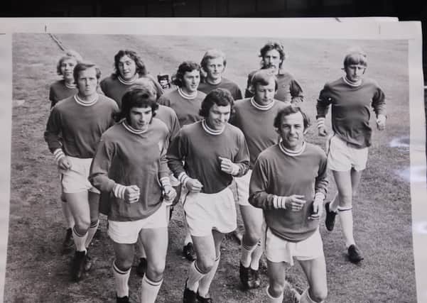 Tommy Robson, front right, leads Posh players on a training run.