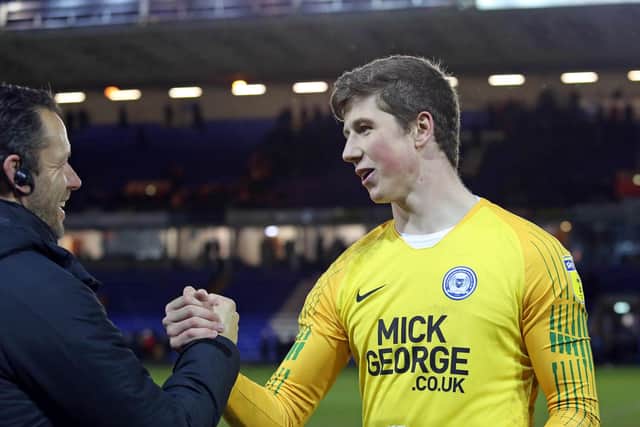 Posh goalkeeper Conor O'Malley with club goalkeeping coach Mark Tyler.
