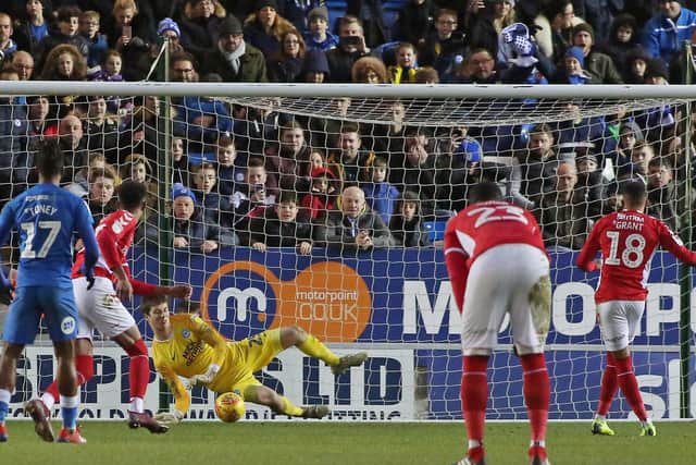 Conor O'Malley of Peterborough United saves a penalty from Karlan Ahearne-Grant of Charlton Athletic last season.