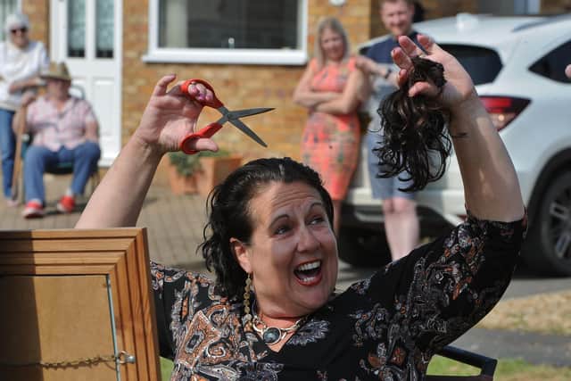 Sally Dowers from Whittlesey doing her own head shave to raise funds for Sue Ryder