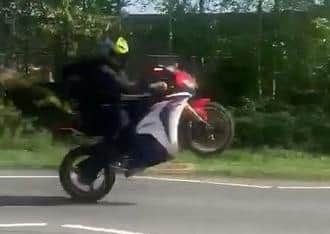 The biker pulling a wheelie