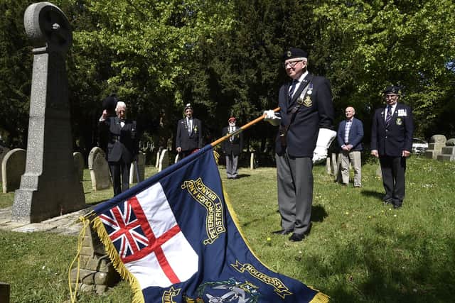 ANZAC Day at the grave of the Lonely ANZAC Sgt Hunter at  Broadway Cemetery. David Clements, the Royal Naval Association standard bearer at the graveside. EMN-200425-161805009