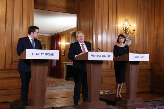 Local Government Secretary Robert Jenrick, Prime Minister Boris Johnson and Deputy Chief Medical Officer Jenny Harries giving a daily Covid-19 press briefing at Downing Street on March 22, Photo by Ian Vogler-WPA Pool/Getty Images