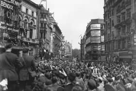 8th May 1945:  Jubilant crowds at Piccadilly Circus, London celebrating victory in Europe.  (Photo by Terry Fincher/Keystone/Getty Images) PPP-191220-154135003