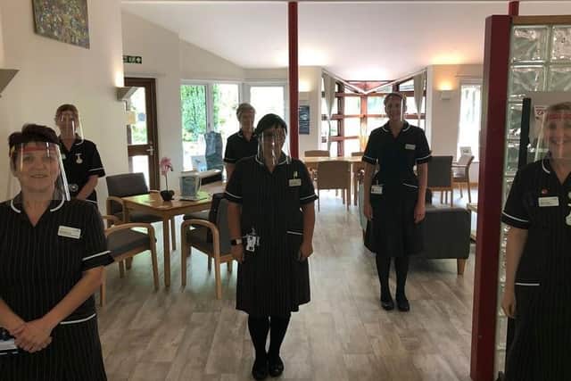 NHS care workers wear protective gear made by Tom Davies.