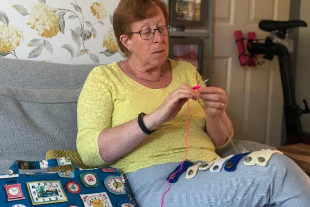 Ann Lymburn who has been knitting together earsavers for carers to wear with their PPE