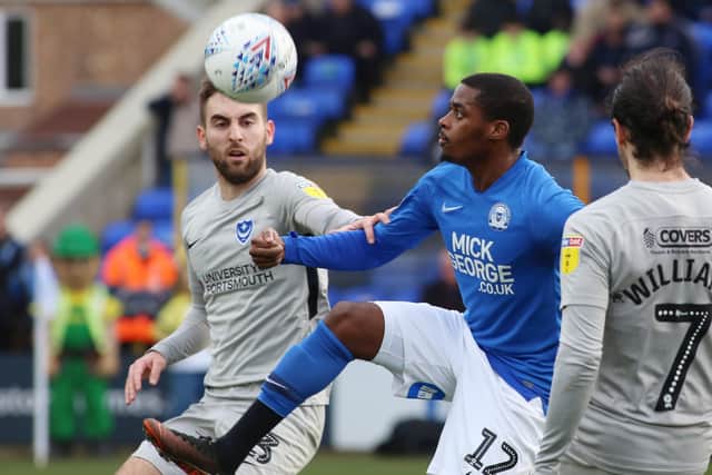 Reece Brown (blue) in action for Posh against Portsmouth on March 7, the last competitive match either side have played.
