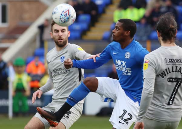 Reece Brown (blue) in action for Posh against Portsmouth on March 7, the last competitive match either side have played.