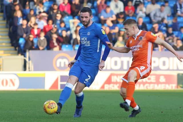 Jason Naismith (blue) in action for Posh last season.