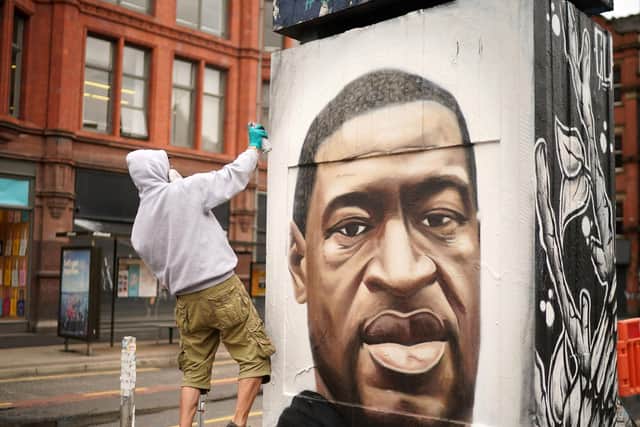 Graffiti artist Akse spray painting a mural of George Floyd (Photo by Christopher Furlong)