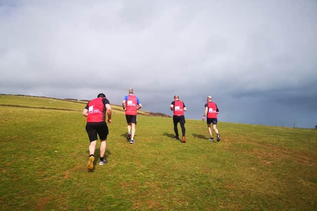 The team running around the hilly coastline near Start PointLighthouse