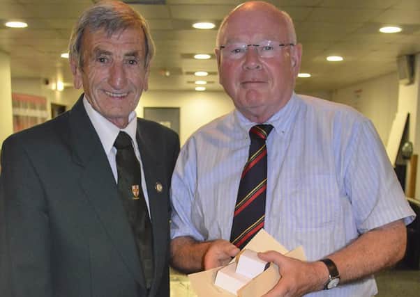 Alan Mutton (right) receiving a long-service football award in 2018.