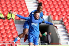 George Cooper celebrates a goal for Posh at Doncaster.