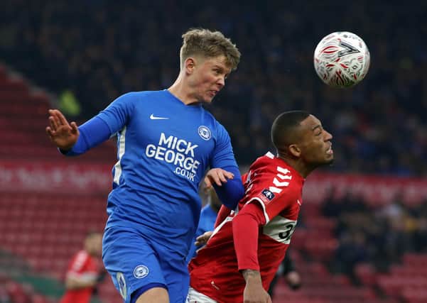 Mark O'Hara (blue) in action for Posh.