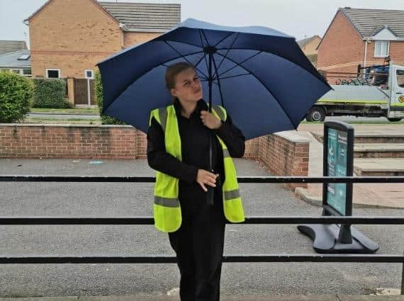 A Co-op staff member with one of the umbrellas