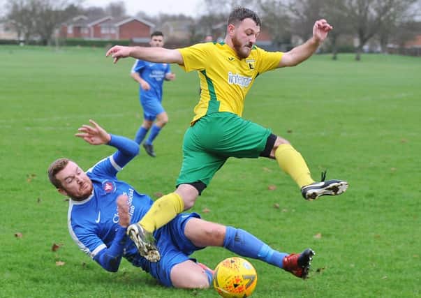 Crowland Town (yellow) in action.