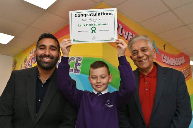 Newark Hill primary school pupil Rojus Pagojus receives a certificate from Goggle Box stars Baasit and Sid Siddigui after winning a competition. EMN-210610-132226009