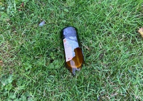A smashed bottle left on the playing field.