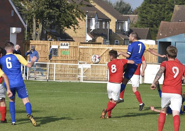Action from Peterborough North End's 2-2 draw with Downham (red) at the Bee Arena. Photo: David Lowndes.