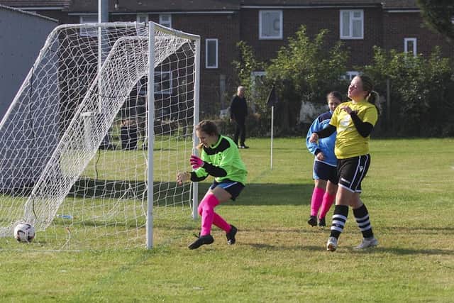 Tia Smith (yellow shirt) has just scored for Peterborough Northern Star Under 12s.  Photo: Tum Symonds.