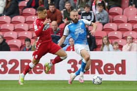 Dan Butler of Peterborough United in action with Marcus Tavernier of Middlesbrough. Photo: Joe Dent/theposh.com.