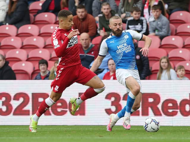 Dan Butler of Peterborough United in action with Marcus Tavernier of Middlesbrough. Photo: Joe Dent/theposh.com.