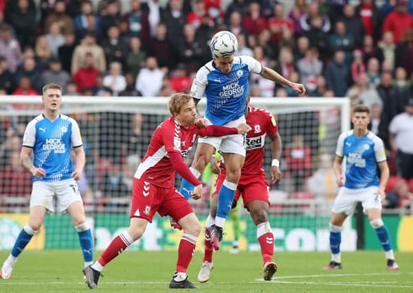 Oliver Norburn of Peterborough United beats Duncan Watmore of Middlesbrough to a header. Photo: Joe Dent@theposh.com.