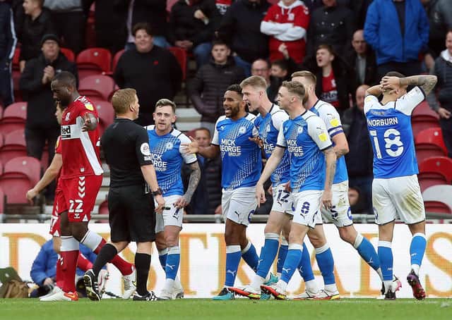 Peterborough United players protest to the match Referee John Busby after he awards Middlesbrough a late penalty. Photo: Joe Dent/theposh.com