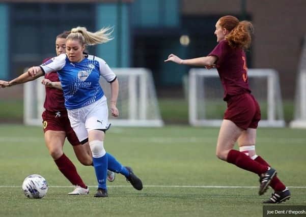 Cassie Steward (blue) scored seven goals for Posh Women against Netherton.