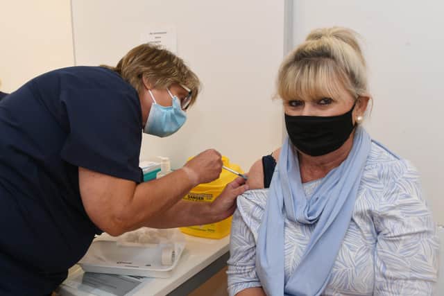 New NHS vaccination centre opens up in the Queensgate shopping centre on Monday. Monica Allen gets her booster jab. EMN-211018-111408009