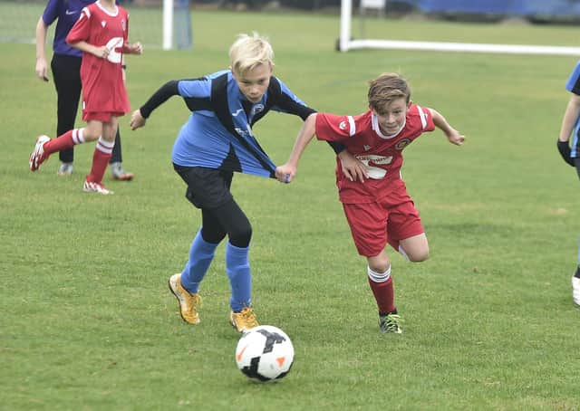 Action from Whittlesey (blue) v Stamford in Under 12 Division Two. Photo: David Lowndes.