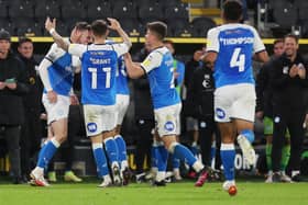 Jack Taylor of Peterborough United is congratulated by team-mates after scoring the opening goal of the game at Hull. Photo: Joe Dent/theposh.com