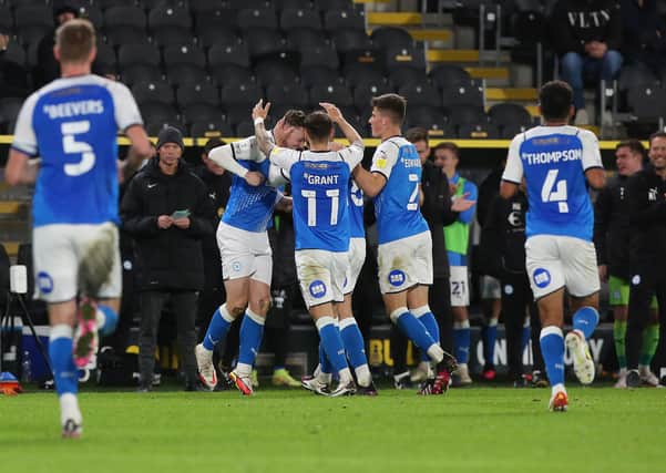 Jack Taylor of Peterborough United is congratulated by team-mates after scoring the opening goal of the game at Hull City. Photo: Joe Dent/theposh.com