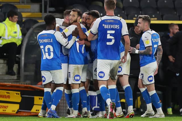 Jack Taylor of Peterborough United is congratulated by team-mates after scoring the opening goal of the game at Hull. Photo: Joe Dent/theposh.com.