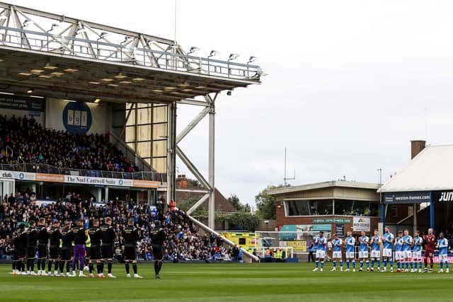 The players of Posh and QPR join in the minute's applause for former Posh star Freddie Hill who passed away earlier this month.  Photo: Joe Dent/theposh.com.