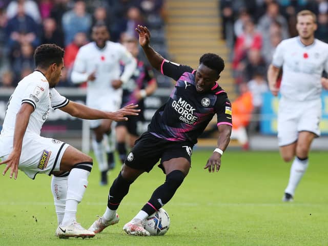 Siriki Dembele of Peterborough United takes on Korey Smith of Swansea City. Photo: Joe Dent/theposh.com