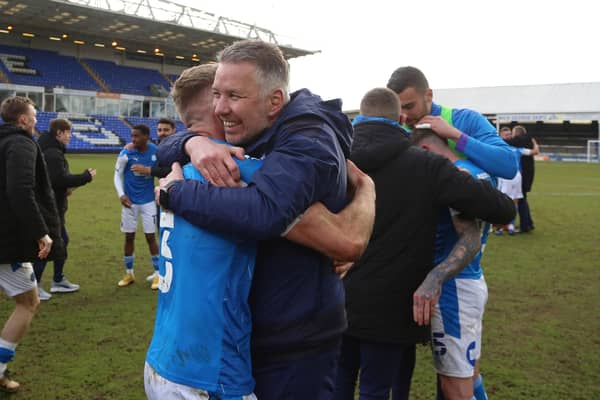 Peterborough United Manager Darren Ferguson celebrates promotion from League One last season with Dan Butler.