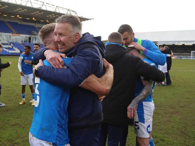 Peterborough United Manager Darren Ferguson celebrates promotion from League One last season with Dan Butler.