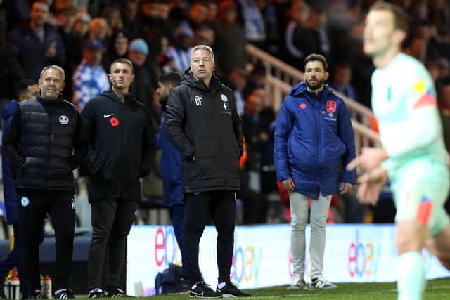 Peterborough United Manager Darren Ferguson watches on from the touchline alongside Huddersfield Town manager Carlos Corberan. Photo: Joe Dent/theposh.com.