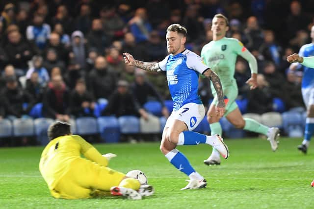 Sammie Szmodics of Posh is just beaten to the ball by Huddersfield goalkeeper Lee Nicholls. Photo: David Lowndes.