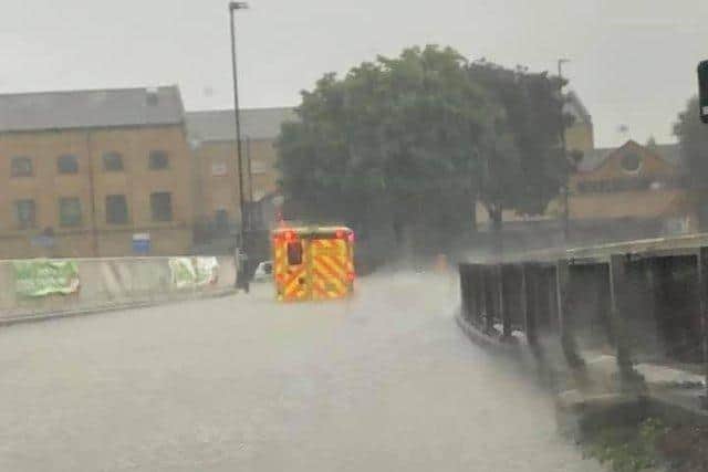 An ambulance gets stuck in flood waters on Bourges Boulevard in July.