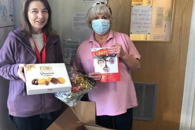 Nursery assistant, Angela Higgins recieving the jampacked boxes from Werrington Lodge Care Home