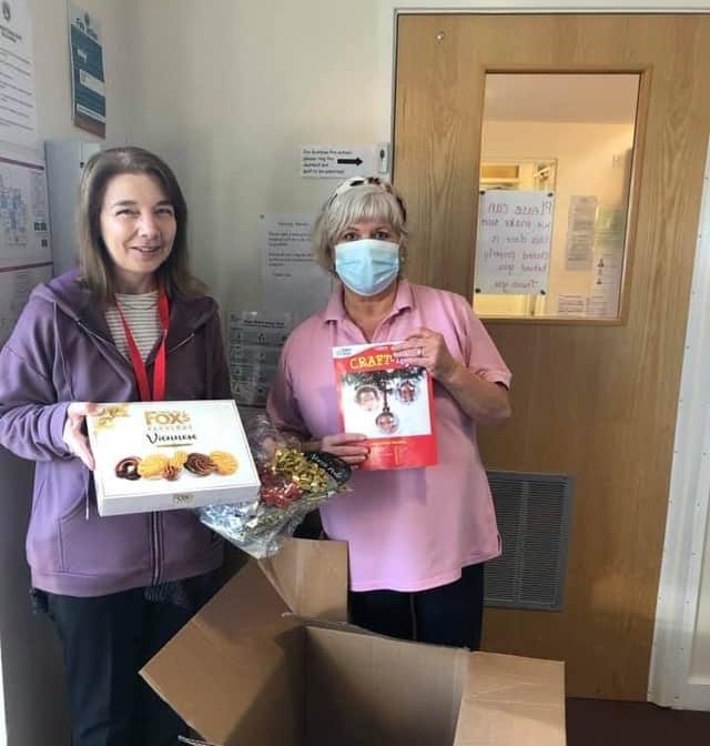 Nursery assistant, Angela Higgins recieving the jampacked boxes from Werrington Lodge Care Home