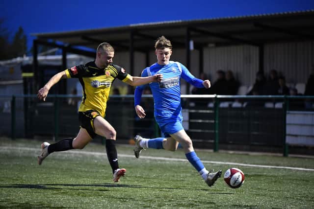 Ryley Nicholson-Barfoot in action for Yaxley (blue) v Belper. Photo: James Richardson.
