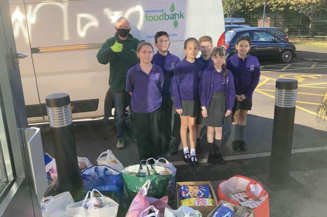 Pupils from Orton Wistow Primary School load up the donations.