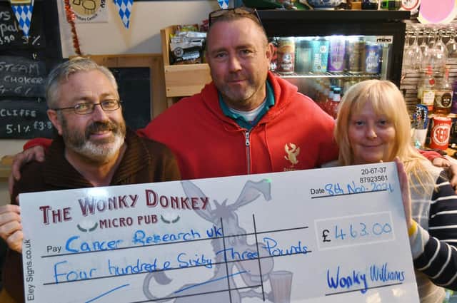 Cancer Research cheque presentation at the Wonky Donkey micro pub from  Dave and Andy Williams to Gaynor Jackson representing the charity. EMN-210911-135823009